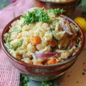 Orzo with cashew cream and roasted vegetables in a bowl.