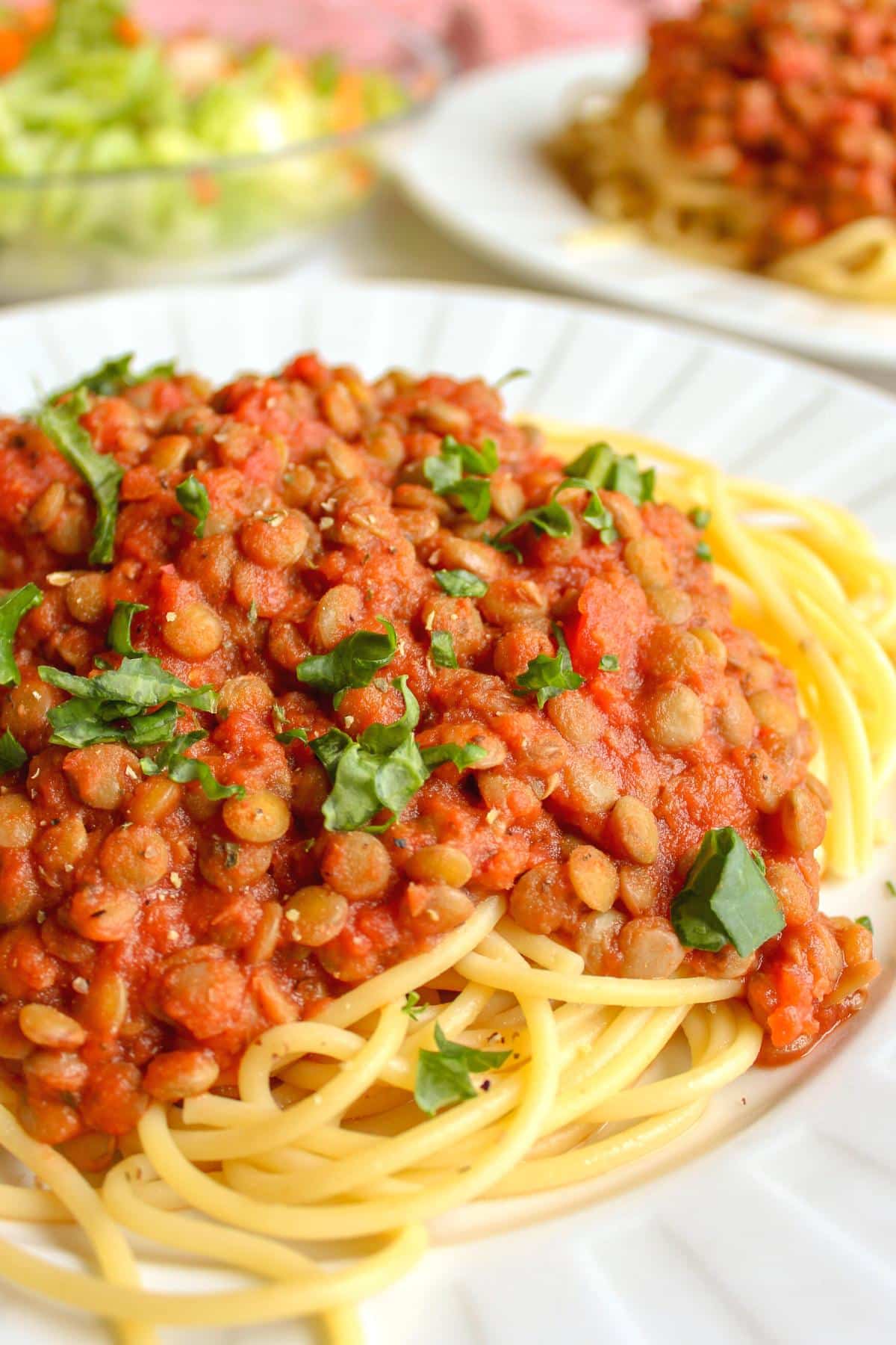 Spaghetti topped with lentil pasta sauce and fresh parsley. 