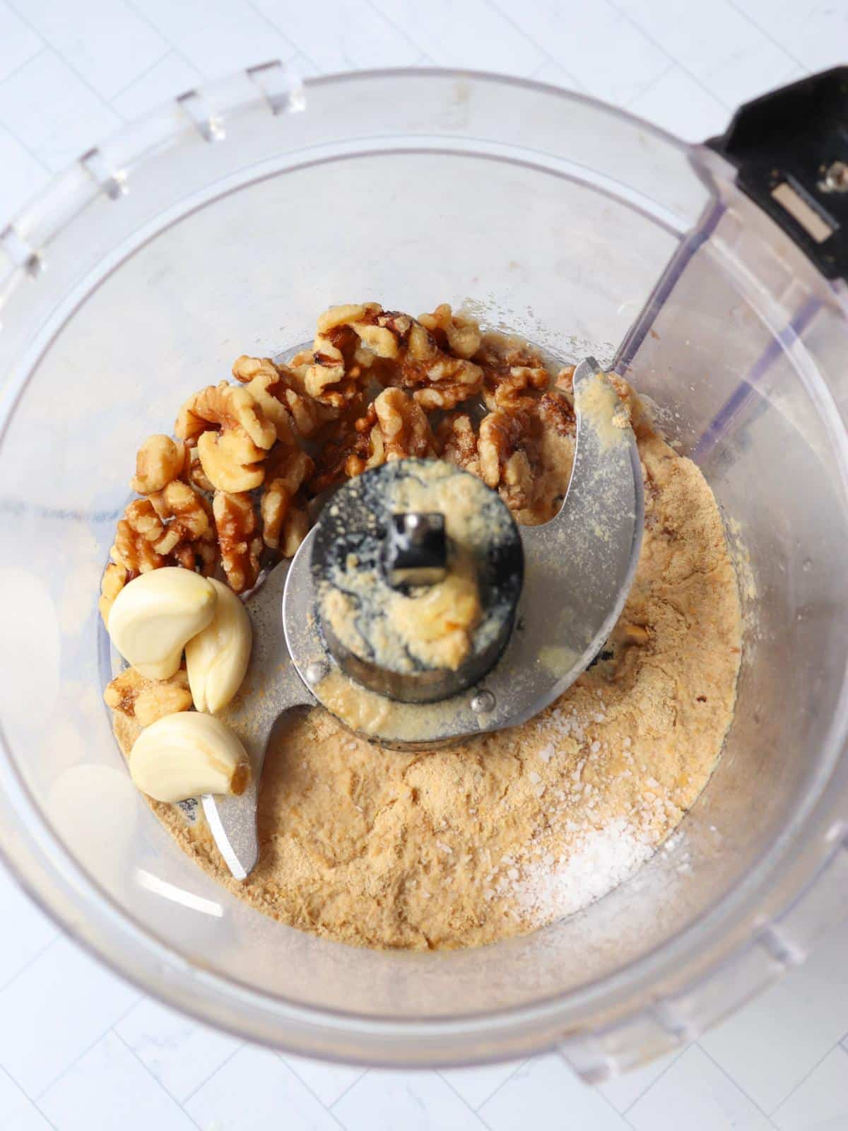 Nuts, garlic, nutritional yeast and salt in a food processor.