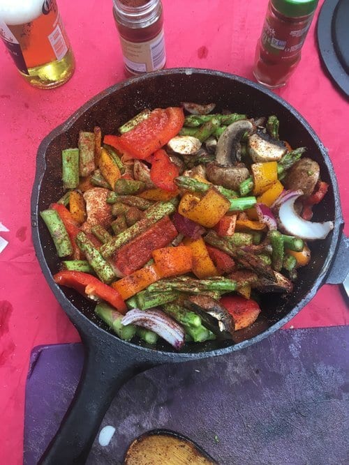 vegetables in a cast iron pot on a picnic table