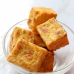 Cubes of crispy tofu in a glass bowl