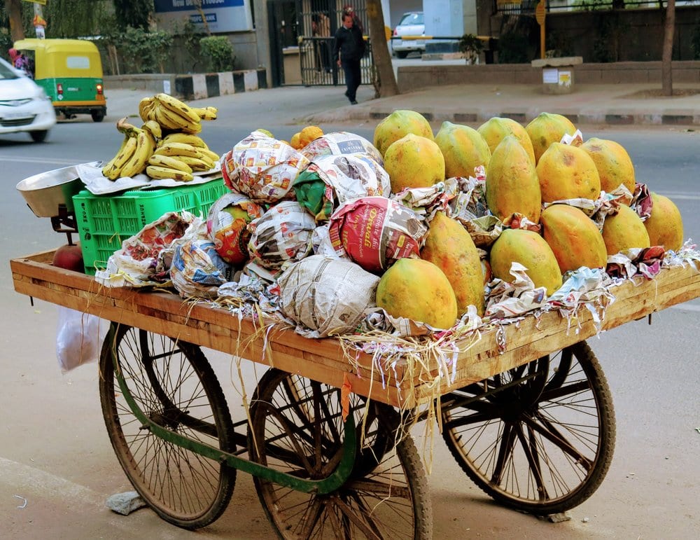 A cart full of fruit on a street