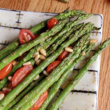 Asparagus and roasted tomatoes on a plate