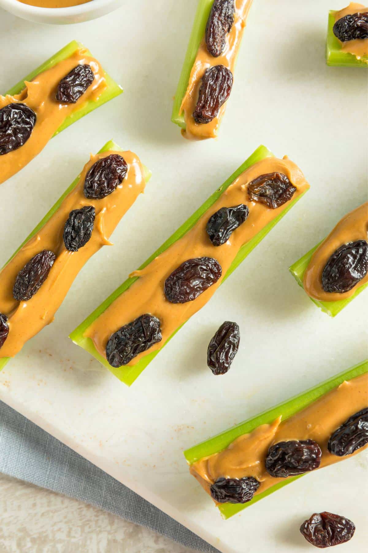 Celery with peanut butter and raisins on top.
