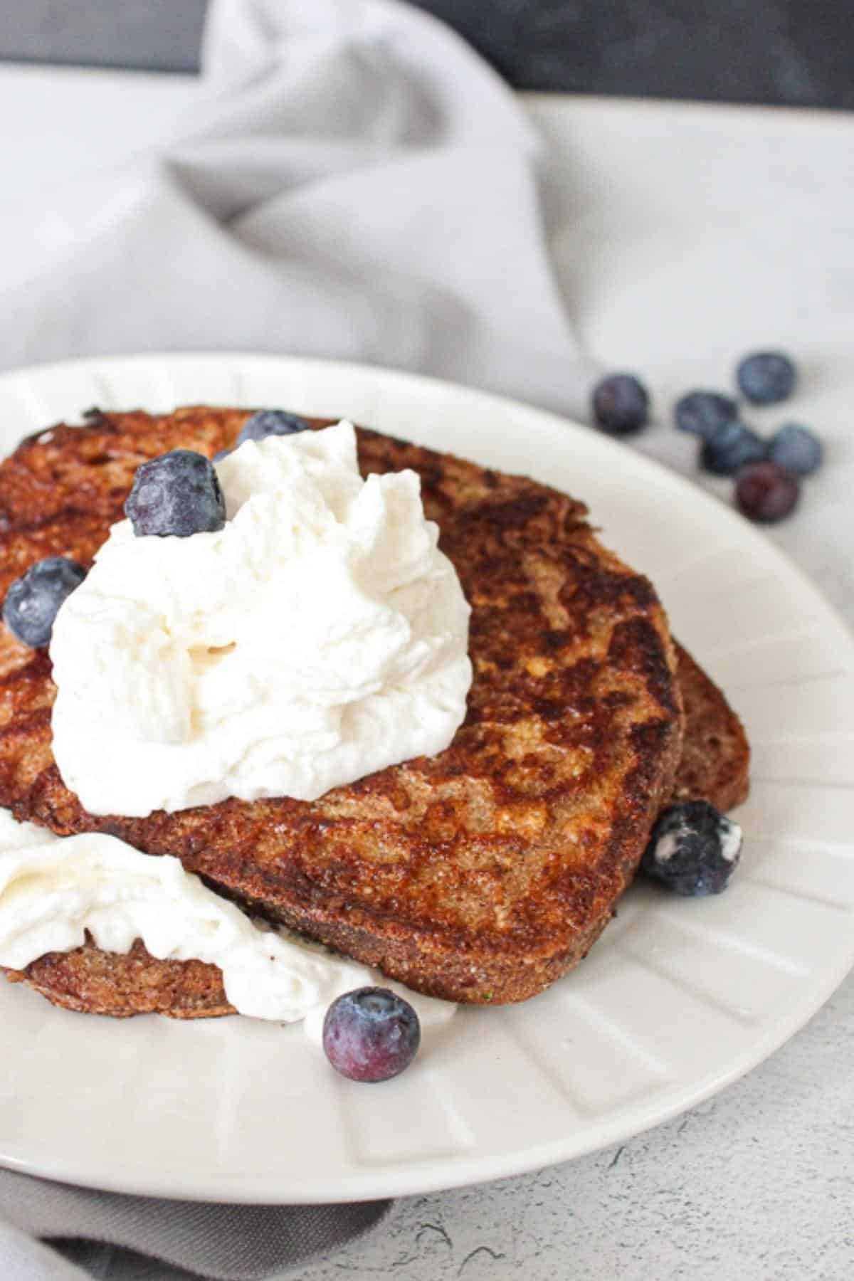 Vegan french toast with whipped cream and blueberries