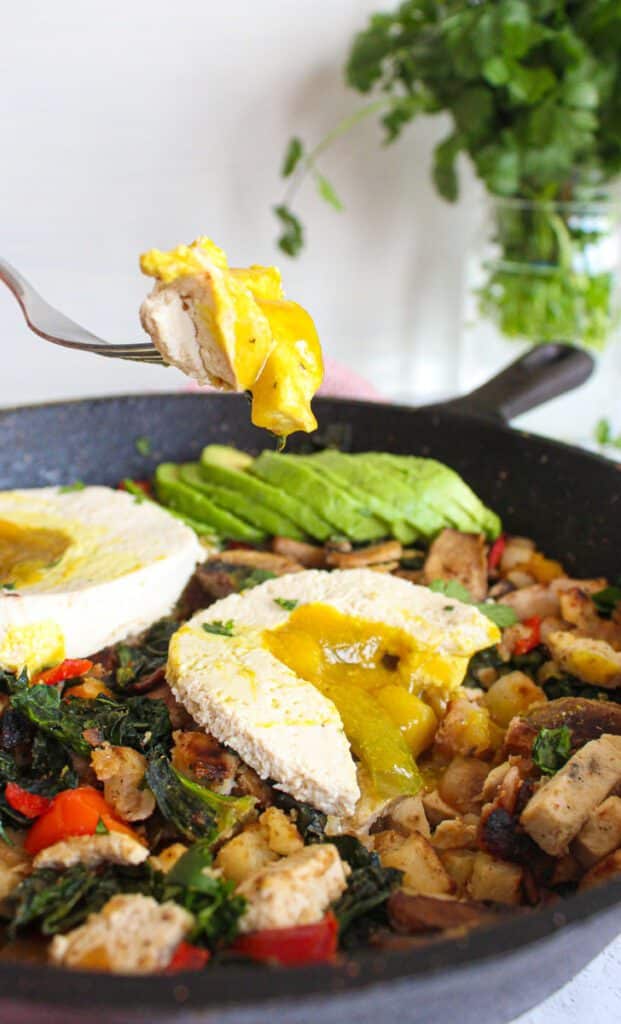 cast iron skillet with vegan breakfast hash. Runny vegan egg yolk