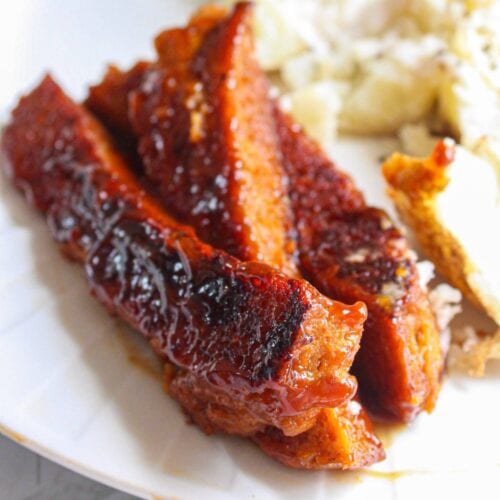 Close up of bbq seitan ribs on white plate