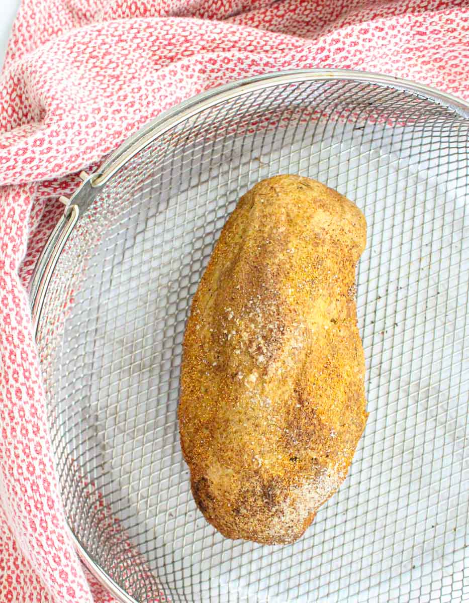 Crispy air fryer baked potato in the air fryer basket