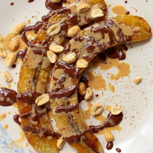 caramelized air fryer bananas topped with melted chocolate and peanut butter