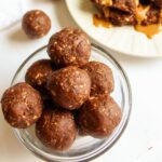 Date balls in a small glass serving bowl