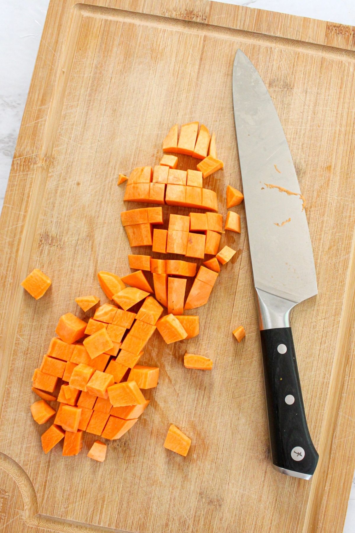 Sweet potato cubes on a cutting board