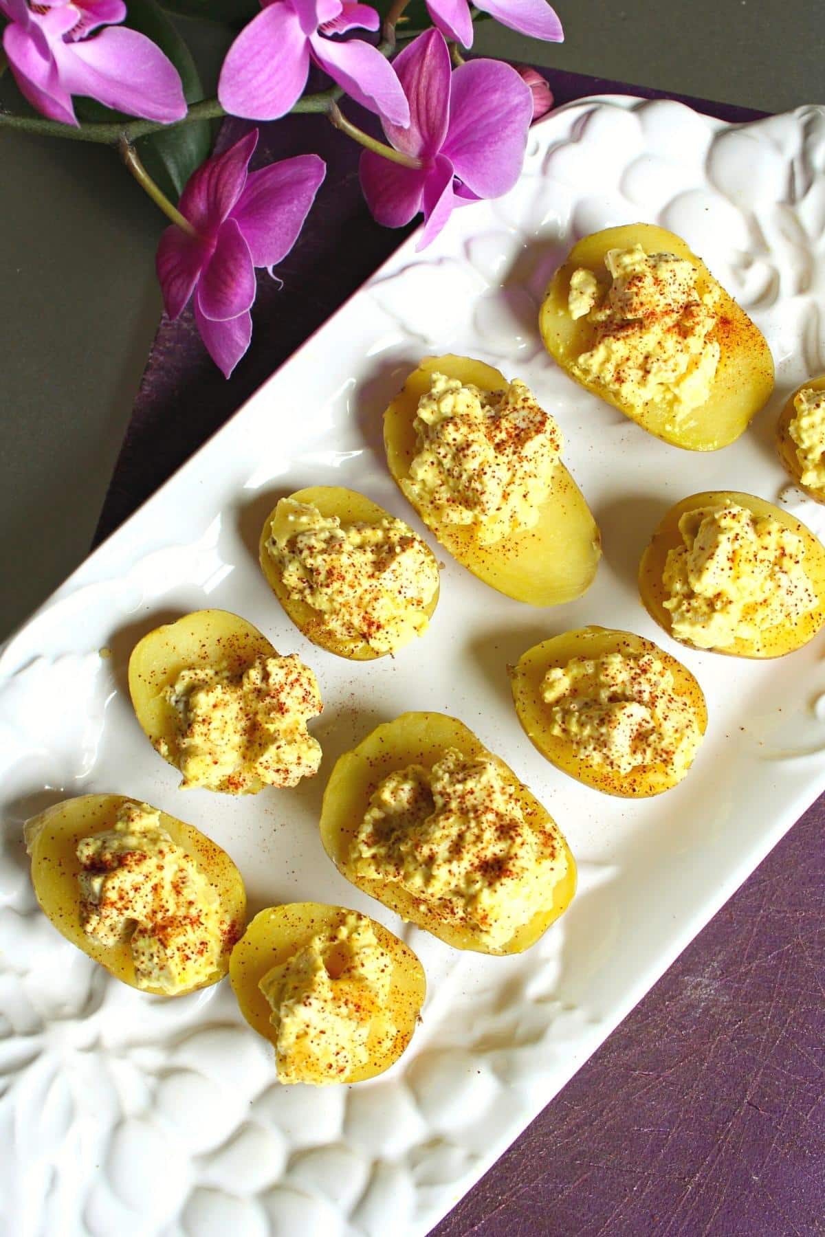 Top view of white serving tray filled with vegan deviled eggs.