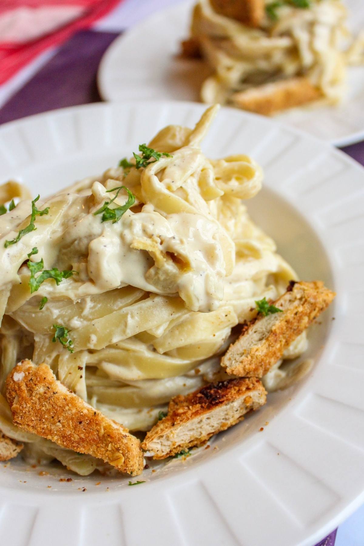 Dairy free fettuccini alfredo in a bowl with vegan chicken