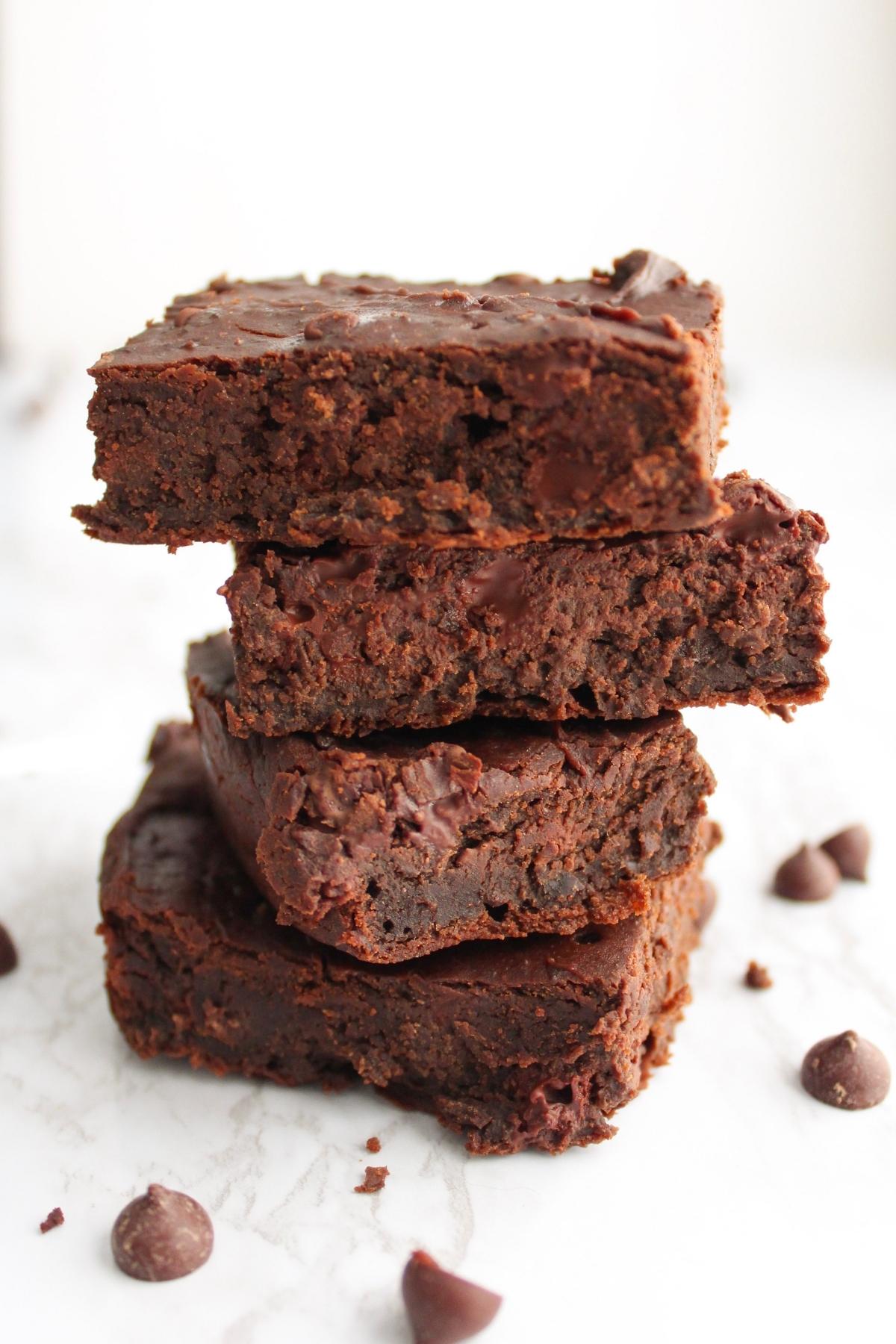 Stack of four vegan black bean brownies stacked on top of each other