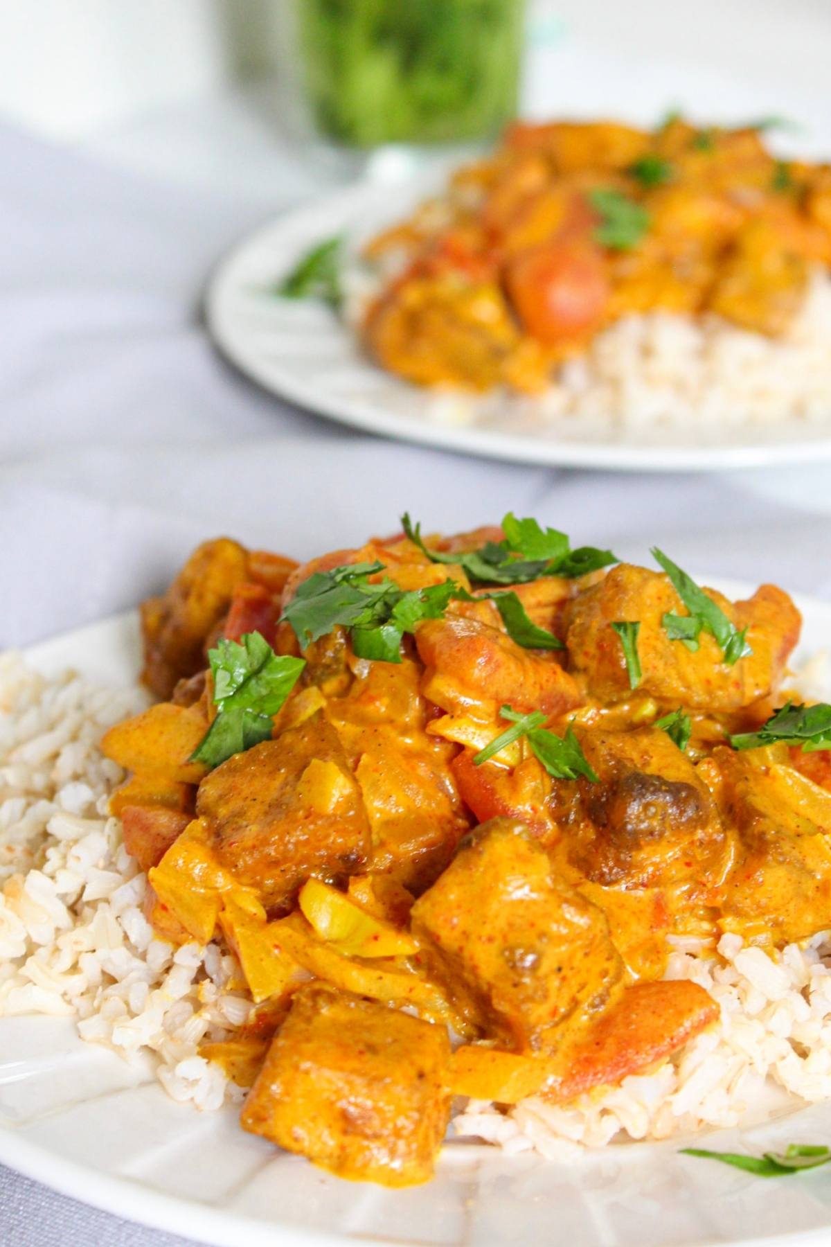 Close up of vegan butter chicken on a plate with rice