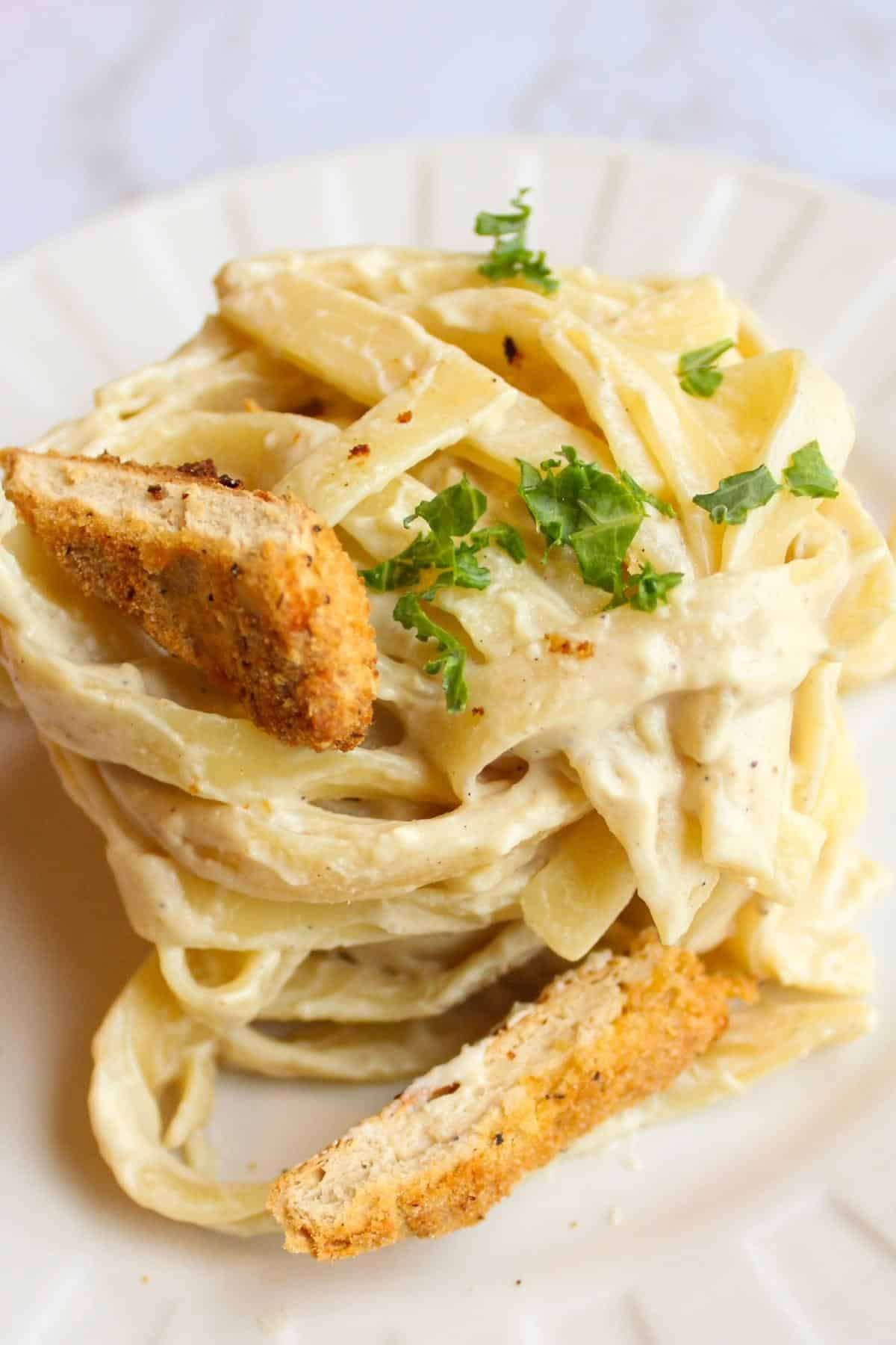 dairy free alfredo sauce on fettuccini noodles with vegan chicken