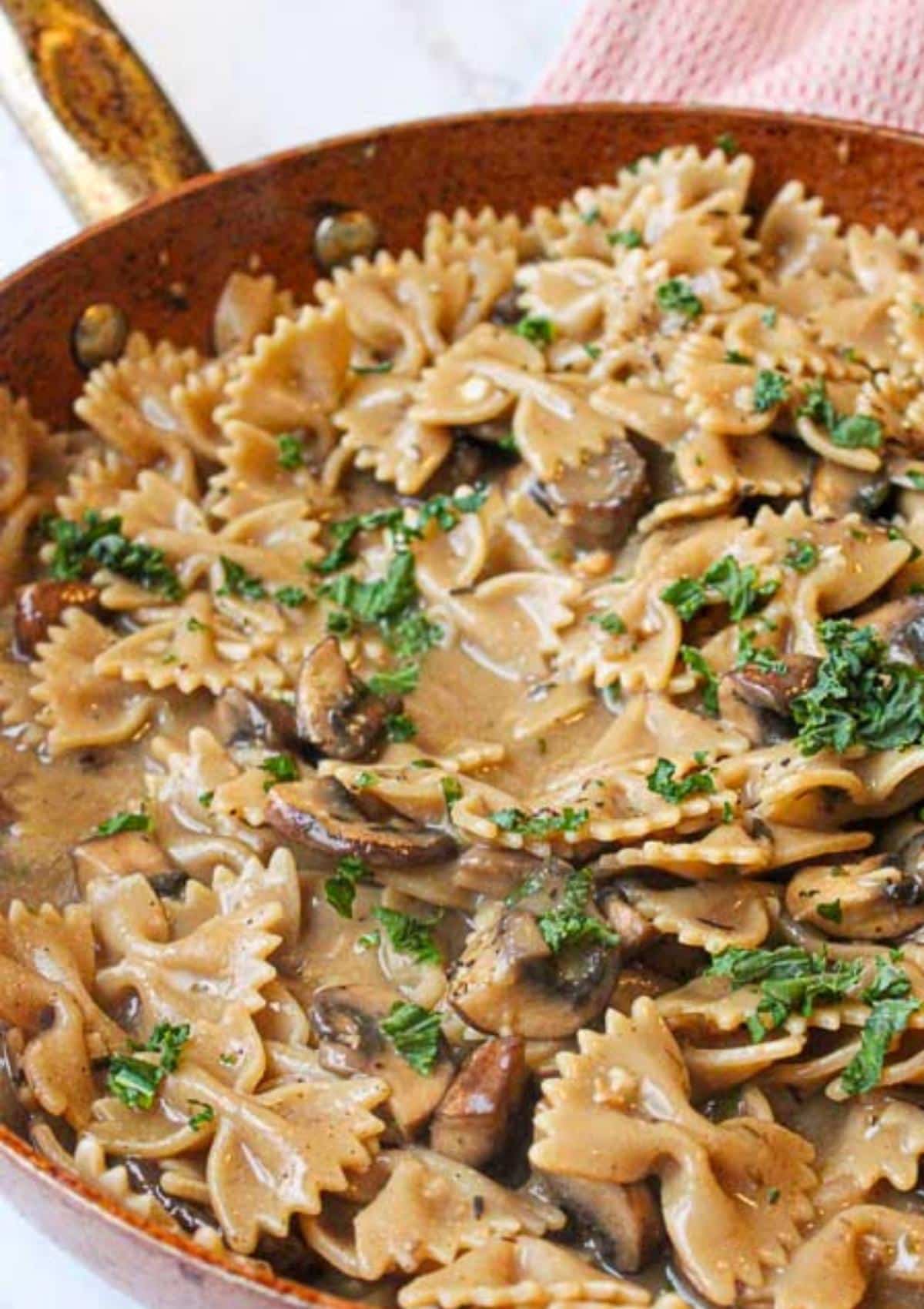 Creamy vegan mushroom pasta in a pan on the stove