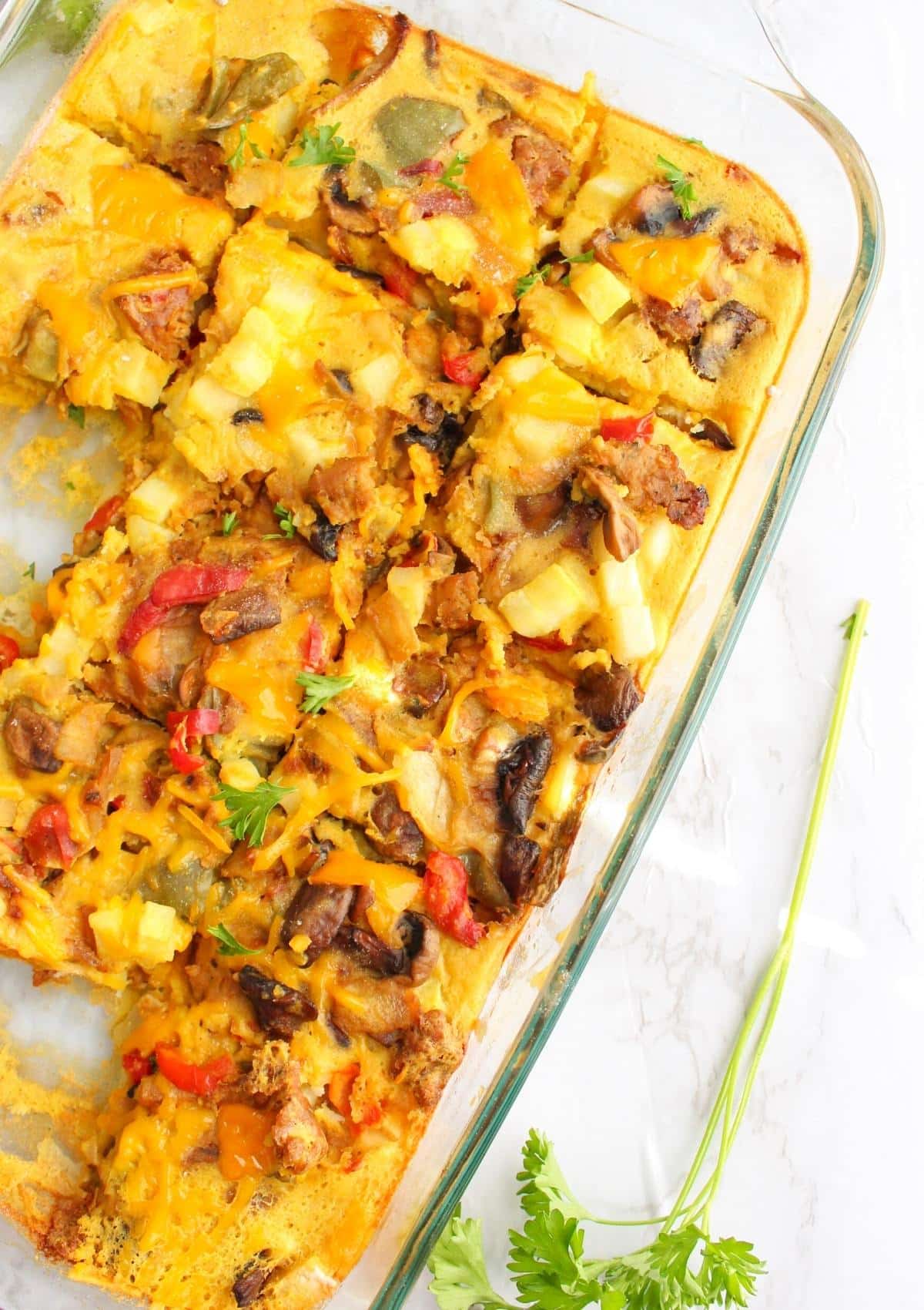Vegan breakfast casserole in a baking dish, cut up into pieces