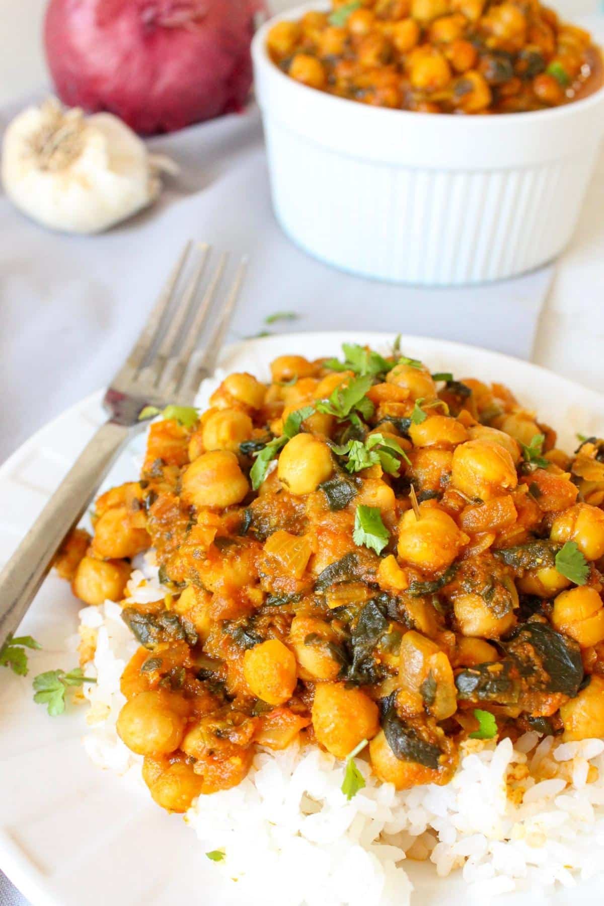 Spinach and chickpea curry on a plate with rice