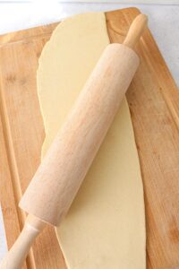 Homemade vegan pasta dough rolled out with a rolling pin