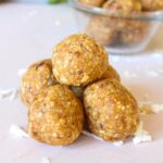 Close up of peanut butter bliss balls stacked on top of each other