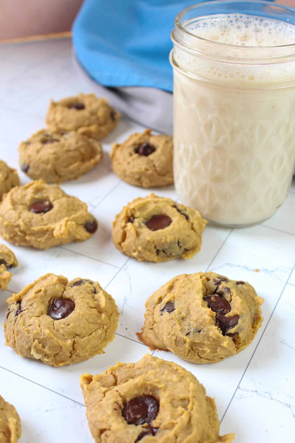 Chickpea chocolate chip cookies on a table with glass of milk