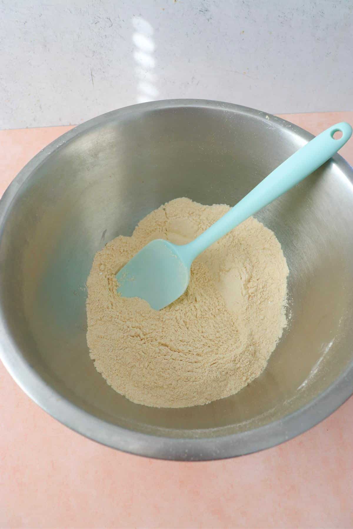 Dry ingredients for vegan protein pancakes in a mixing bowl.