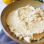 Close up of vegan ricotta in a brown bowl.