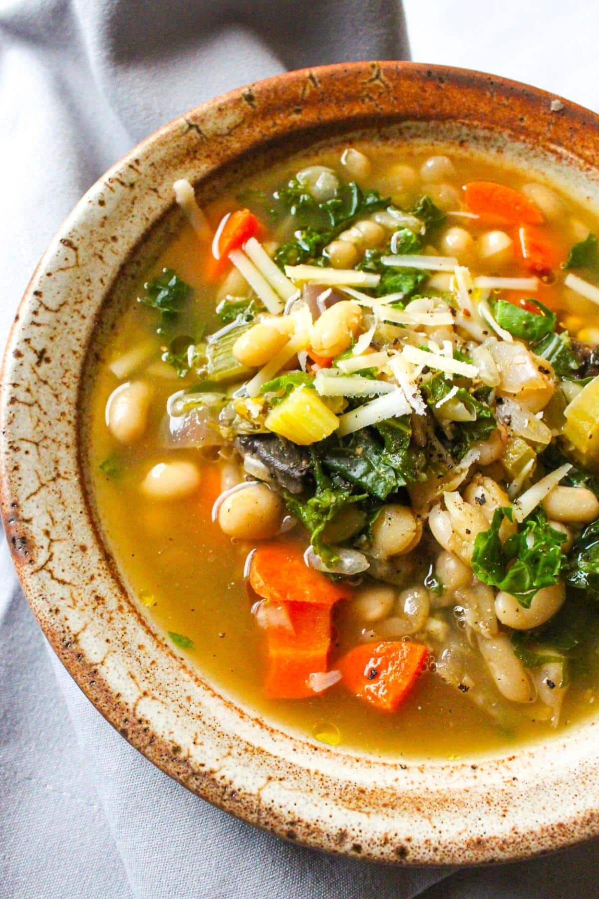 Bowl of vegan white bean soup with kale