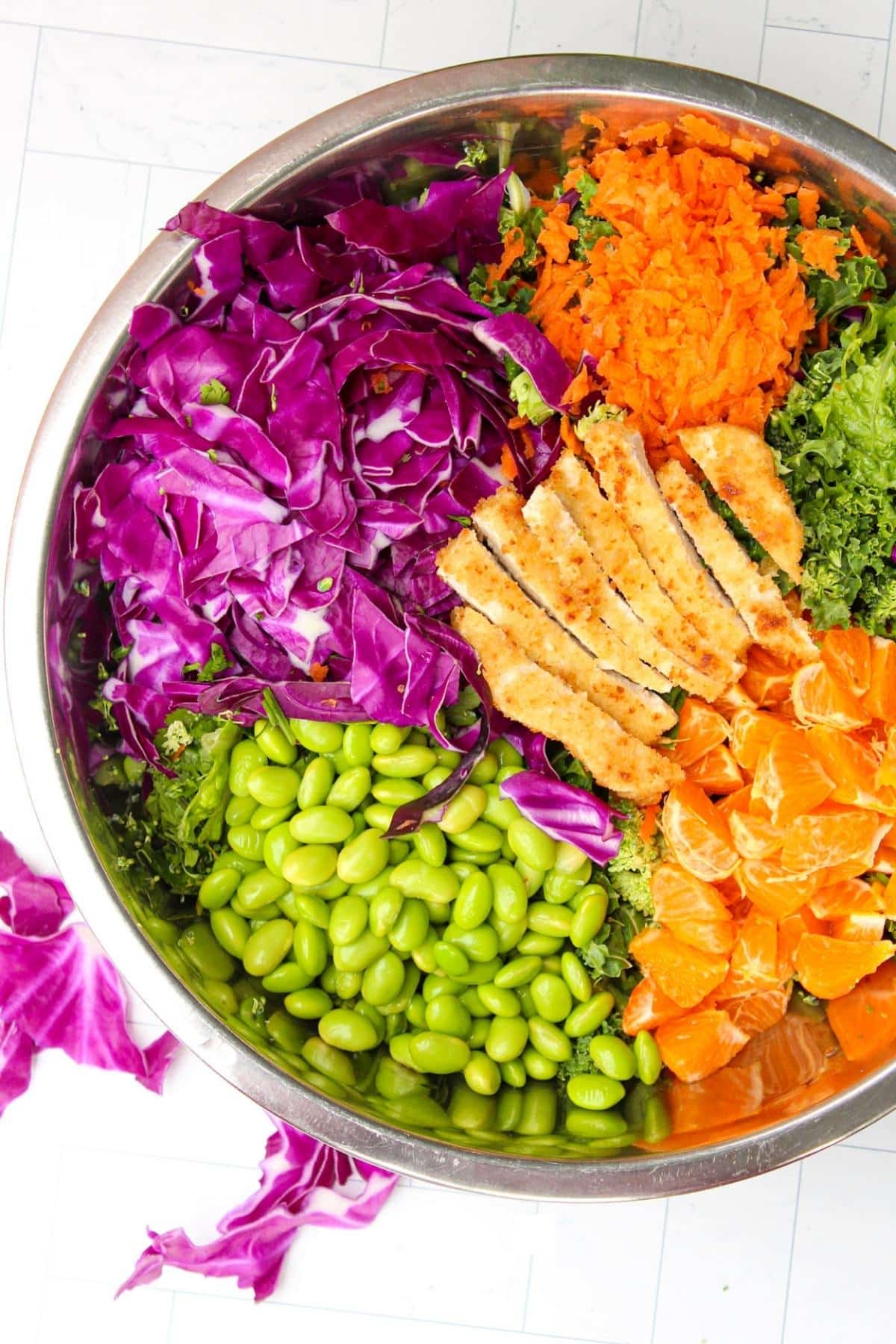 Overhead view of large mixing bowl filled with rainbow salad.