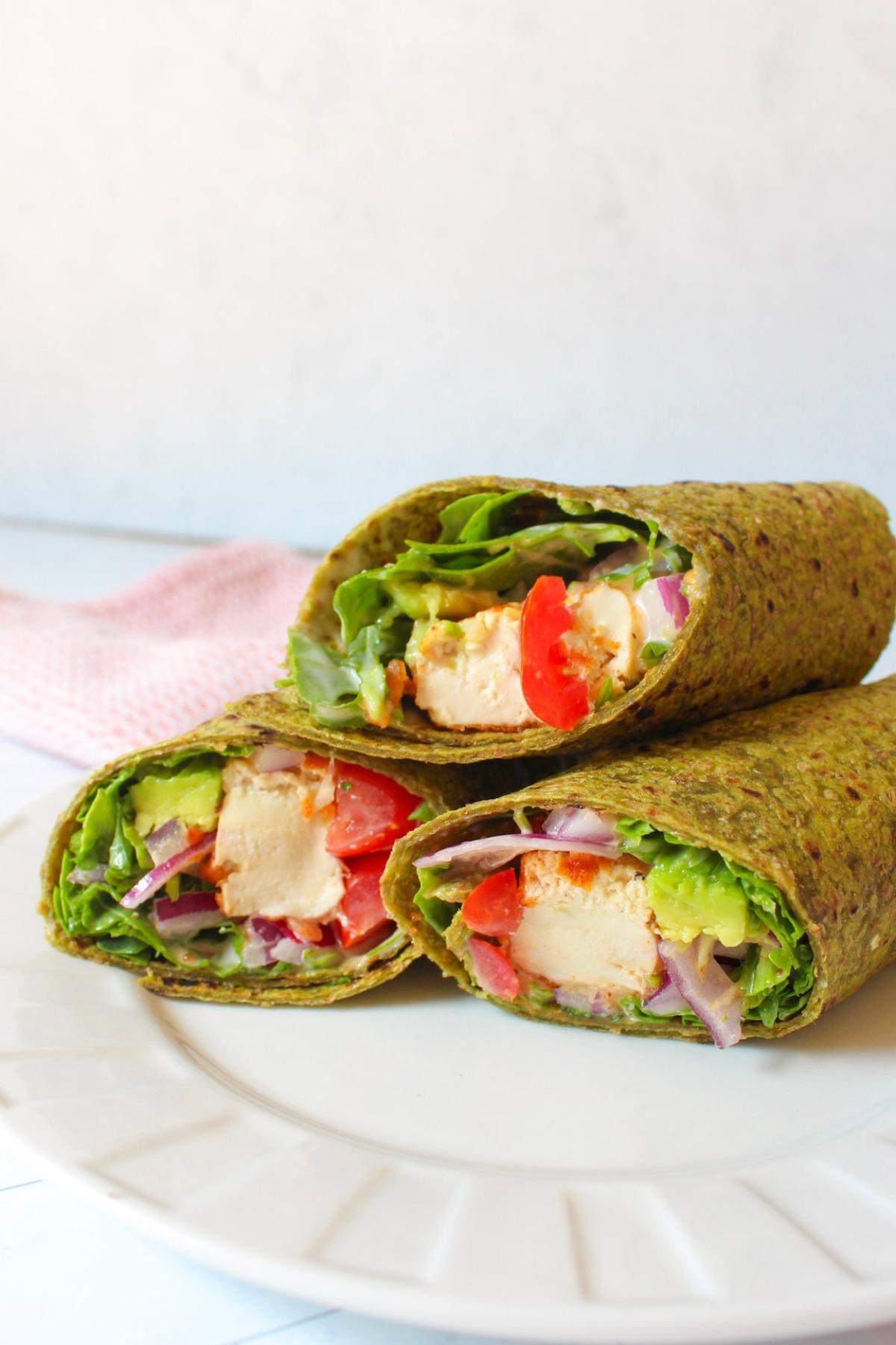 Tofu wraps on a plate, cut in half