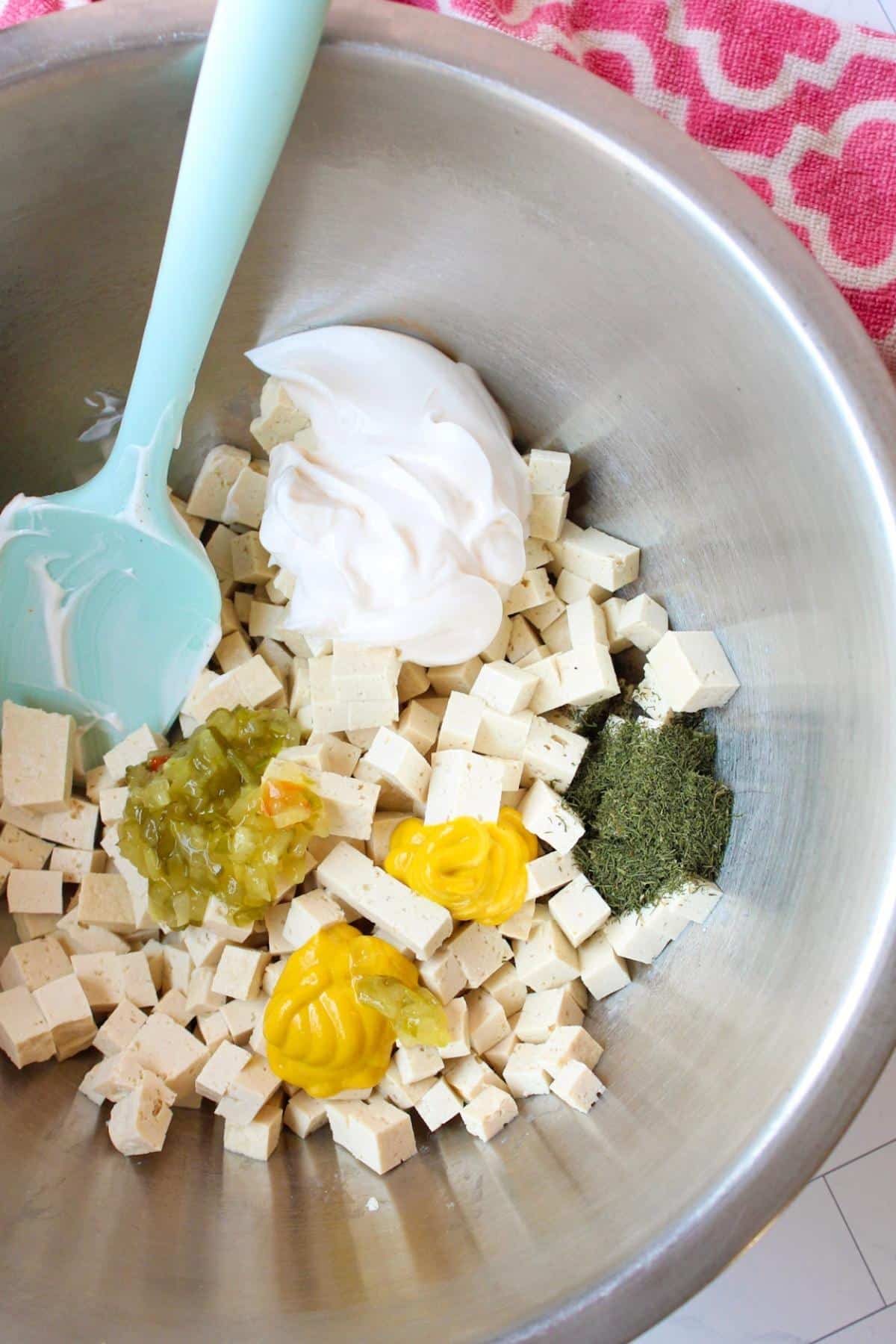 Tofu egg salad ingredients in a large mixing bowl.
