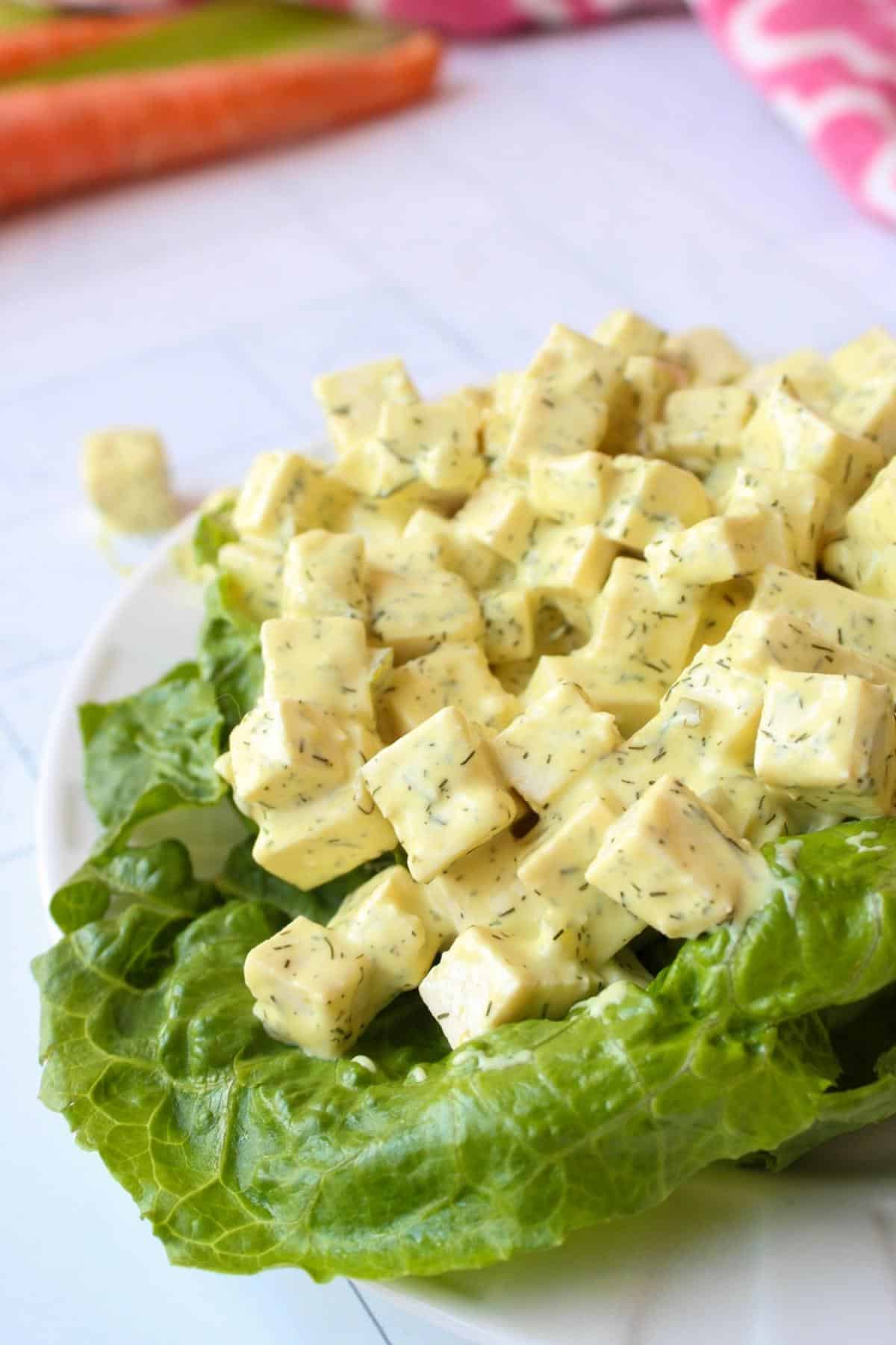 Vegan egg salad made with tofu on a romaine lettuce leaf