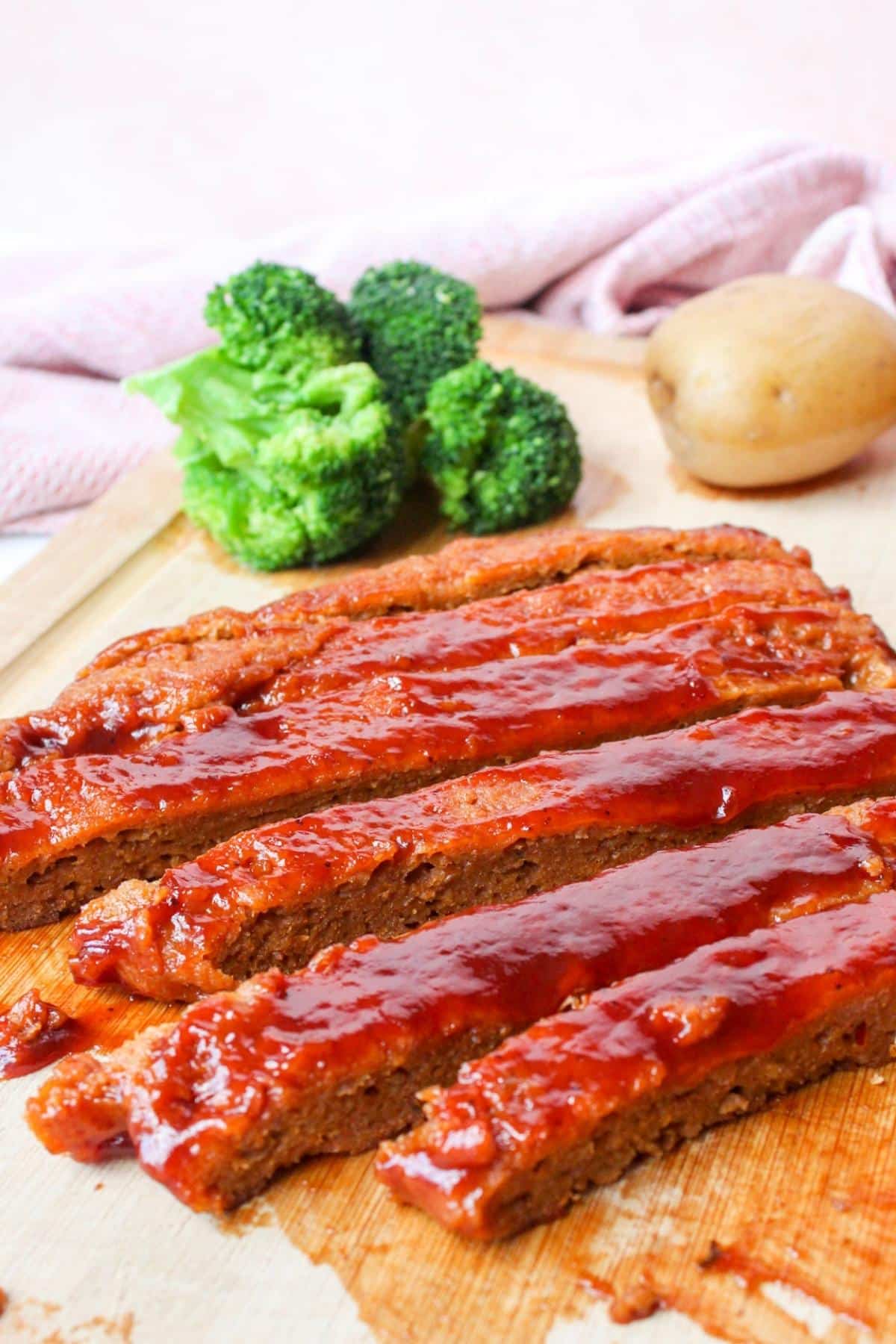 Close up of vegan ribs with steamed broccoli and potatoes