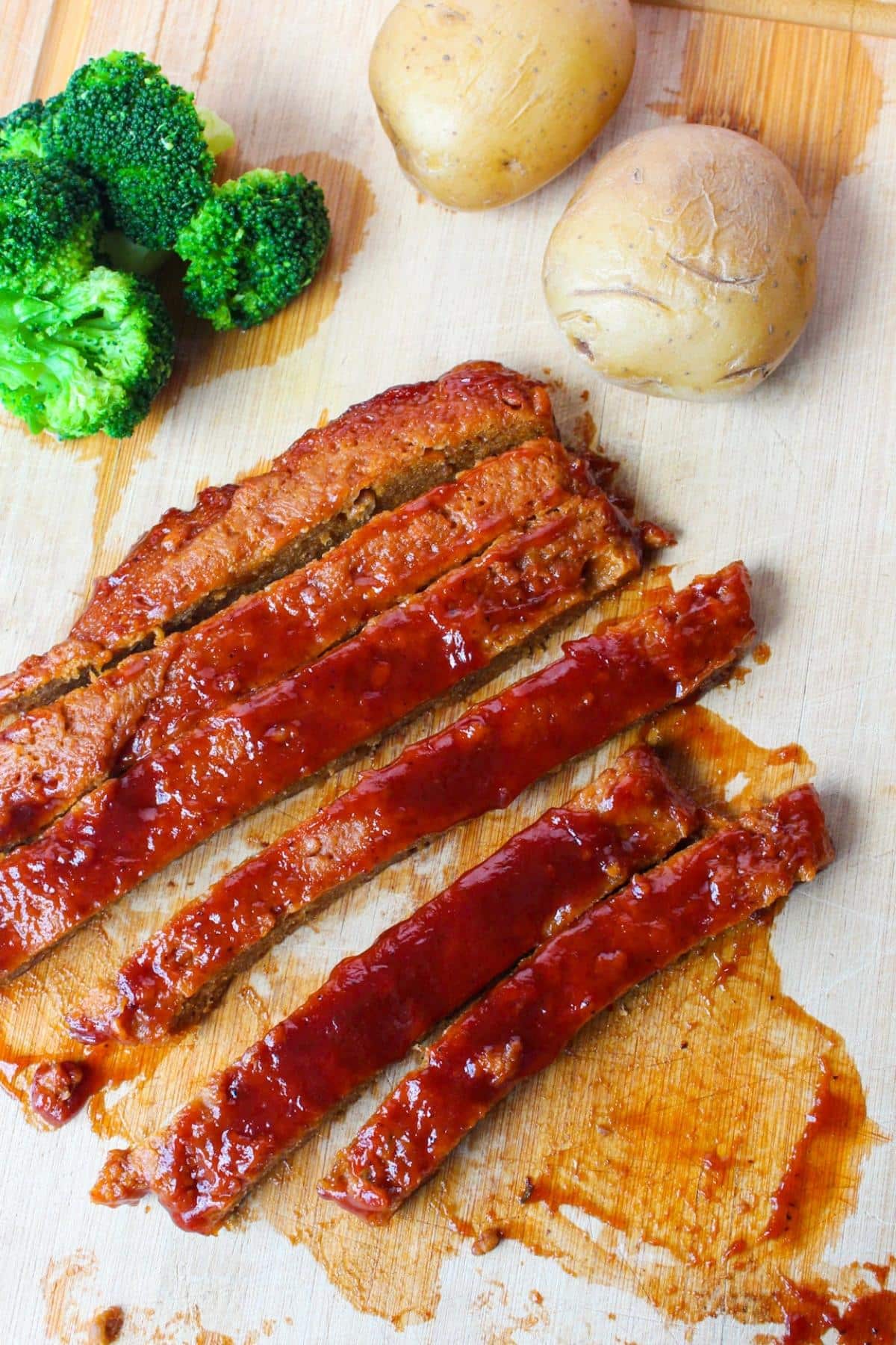 Overhead view of vegan ribs on a cutting board.