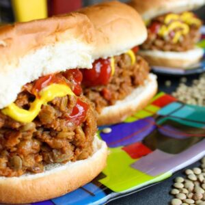 Vegan sloppy joe on a hamburger bun on a plate.