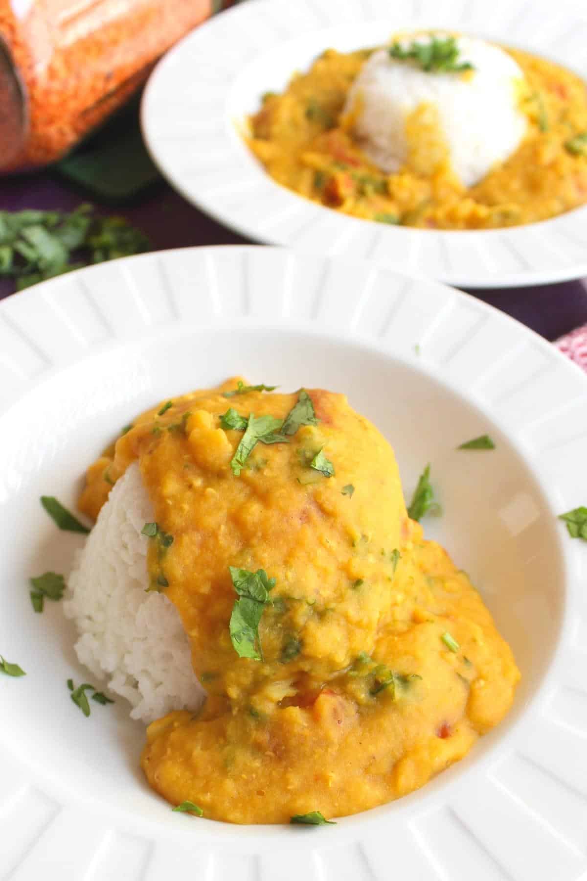 Instant pot red lentil dal in a bowl over rice.