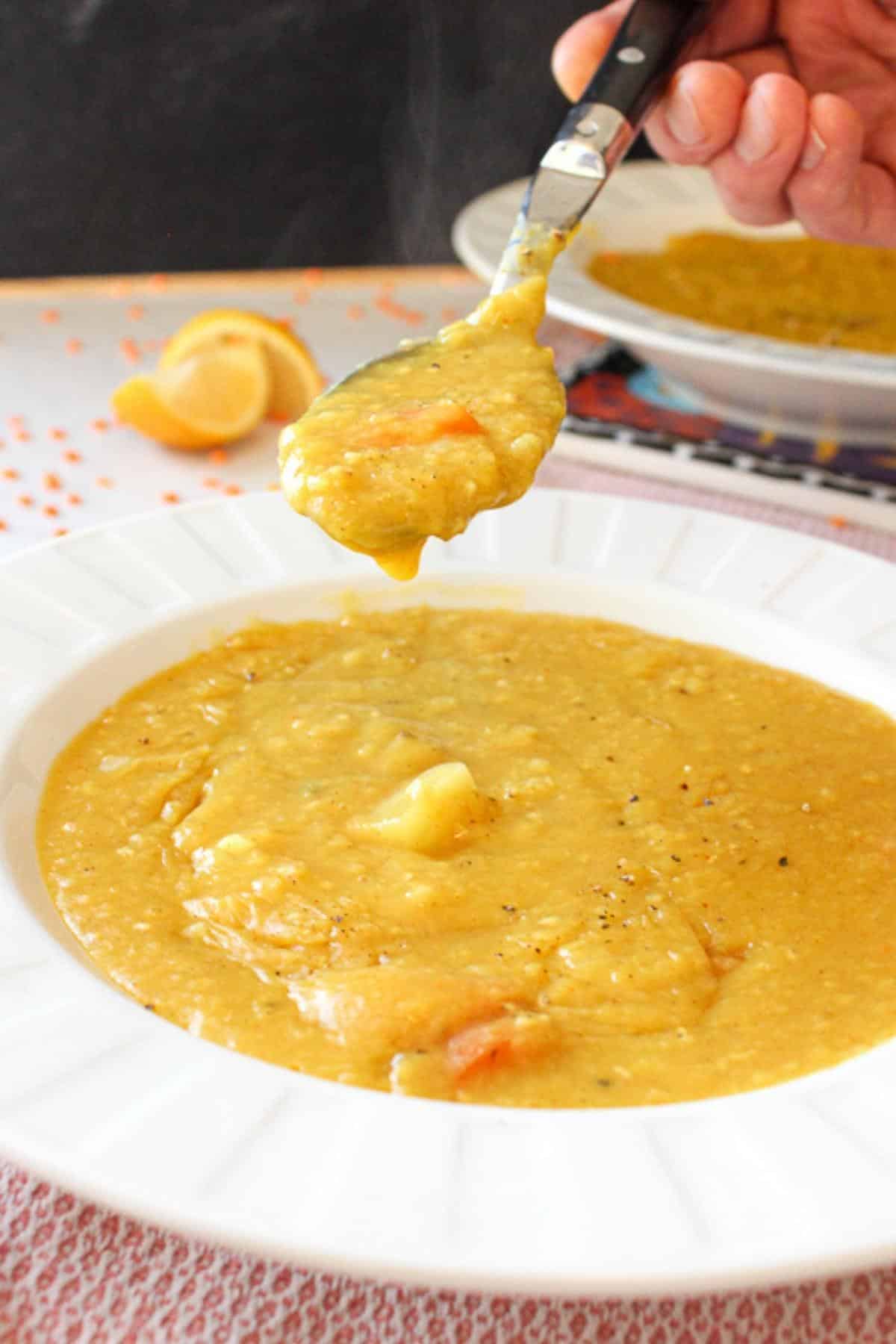 Spoon in a bowl of instant pot red lentil soup