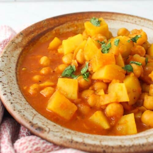 Chickpea and potato curry in a serving dish.