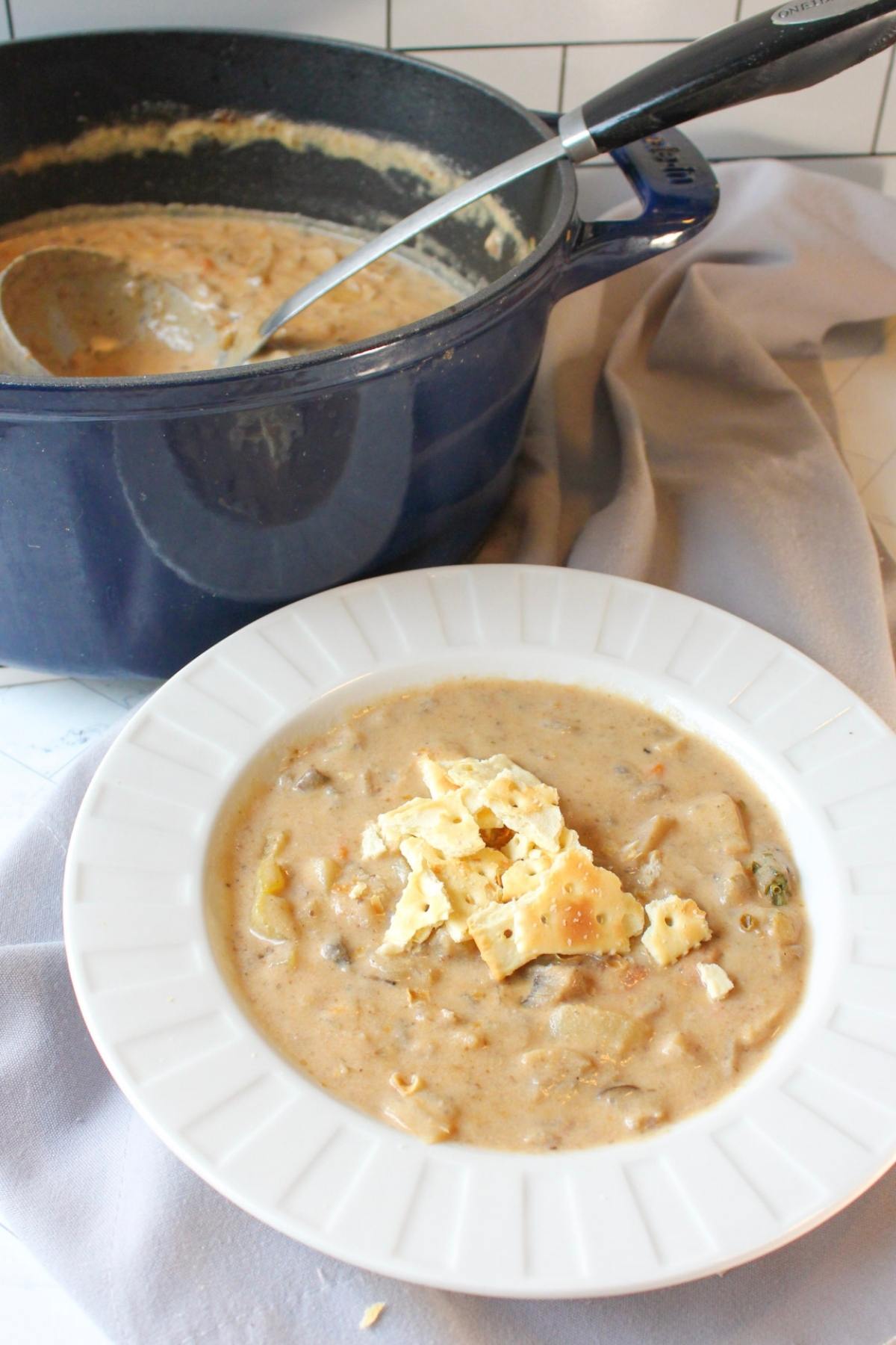 Vegan clam chowder in a large soup pot and serving bowl.