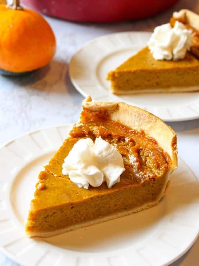 Eggless vegan pumpkin pie on a plate topped with whipped cream
