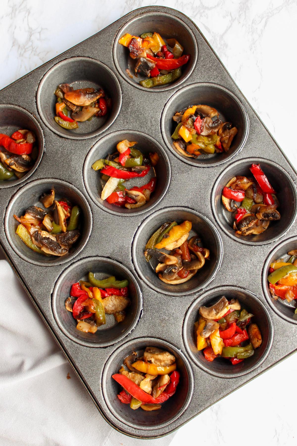 Vegan quiche ingredients in muffin tins.