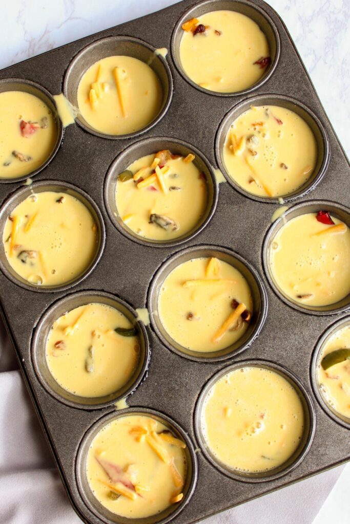 Vegan quiche batter in muffin tins.
