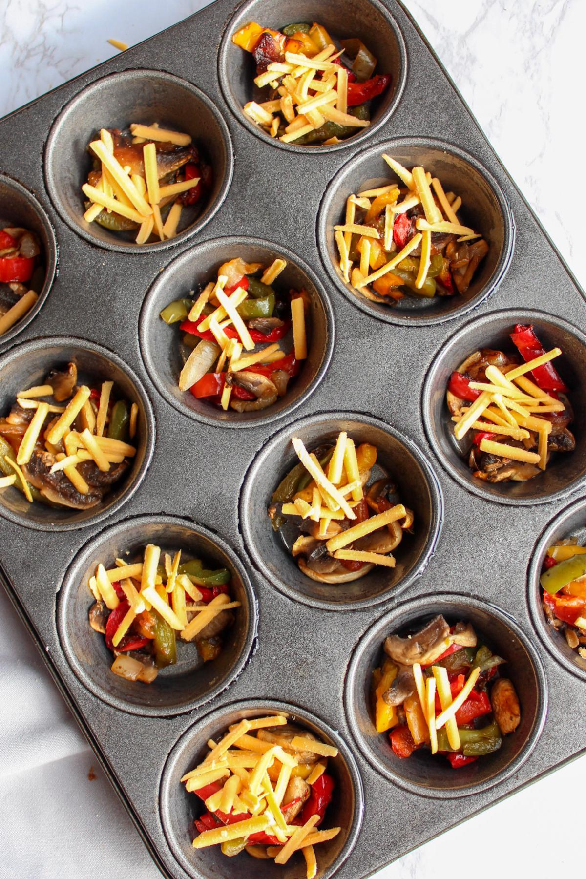 Vegan quiche ingredients in muffin tins.