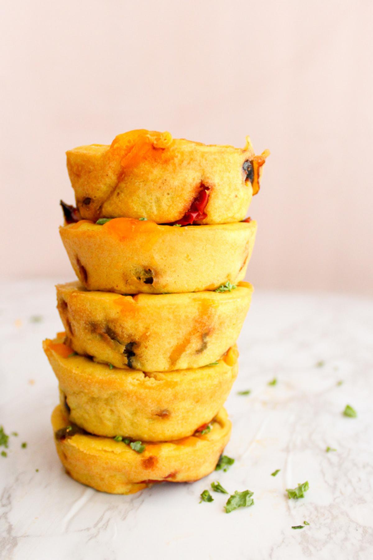 Mini Vegan quiche cups stacked up on top of each other.