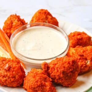 Vegan wings surrounded by a bowl of vegan ranch dressing