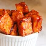 Bbq tofu cubes in a white serving bowl.
