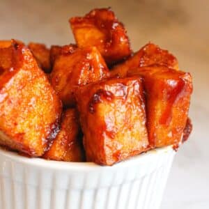 Bbq tofu cubes in a white serving bowl.