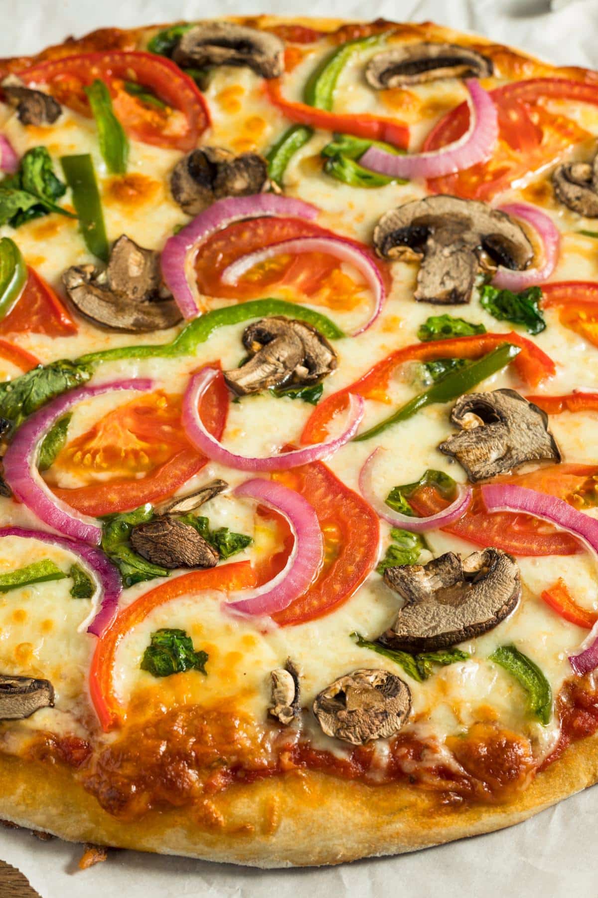 A vegan pizza with veggies on it.