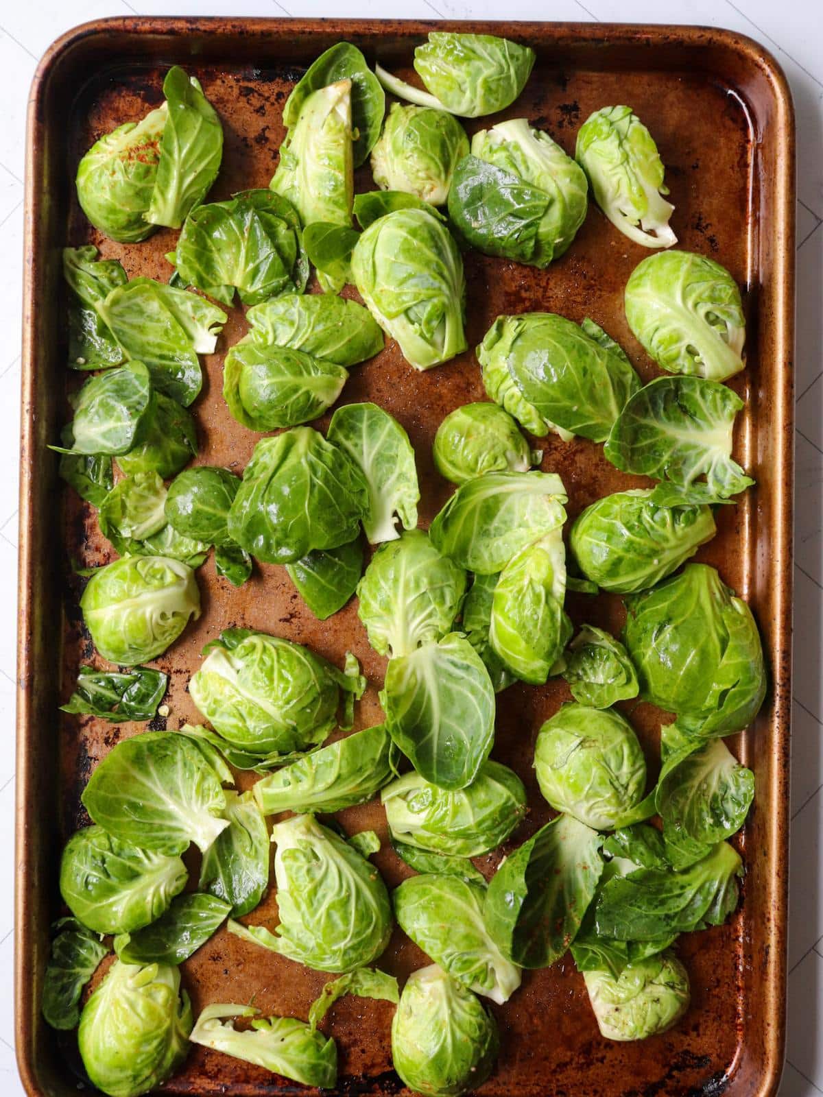 Cut brussels sprouts on a baking sheet, cut side down.